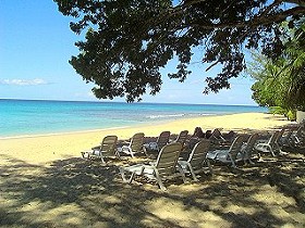 Relax on the beach chairs at Paynes Bay beach.