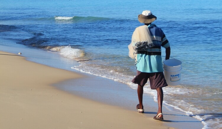 Bajan fisherman strolling along the beach