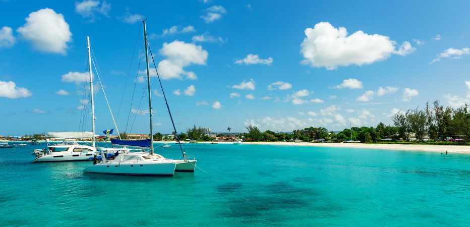 Two catamarans floating on the clear waters of Carlisle Bay