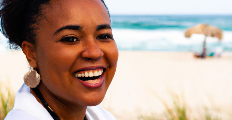 Bajan woman smiling with beach in the background.