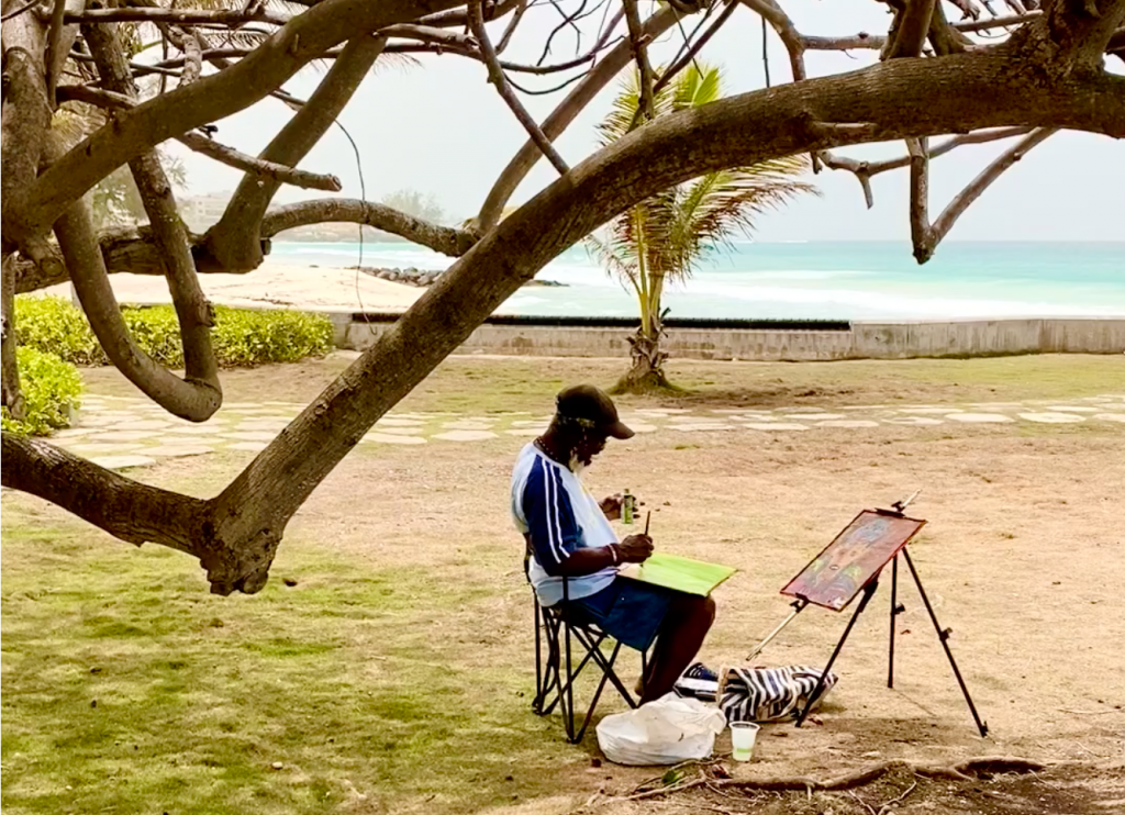 artist-woollyhewitt painting on the beach