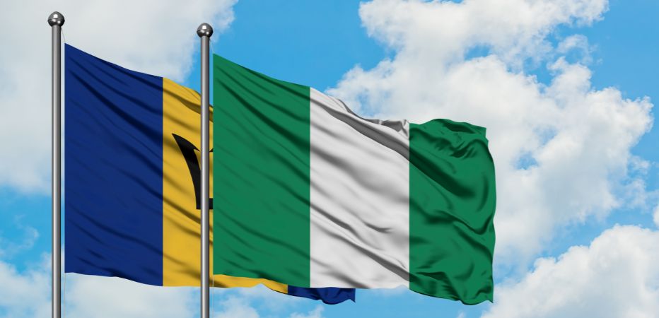 Illustration of Barbados and Nigeria flags flying against a blue cloudy sky