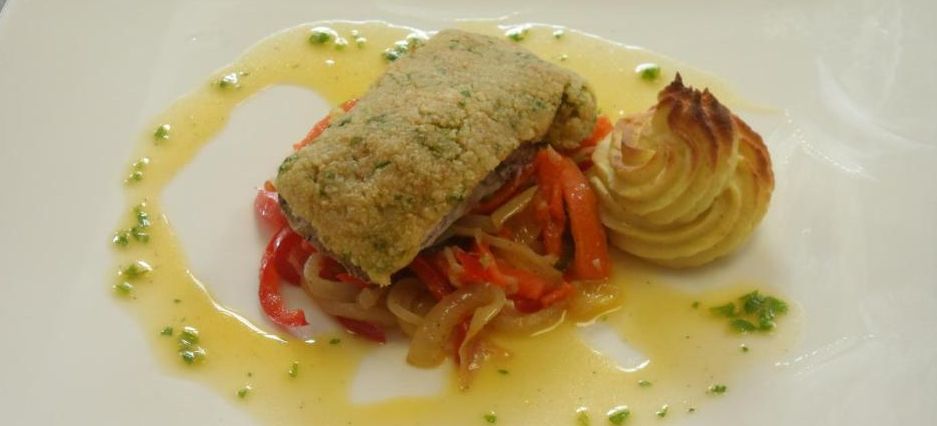 Aesthetically plated meal with fried fish, potatoes and vegetables.