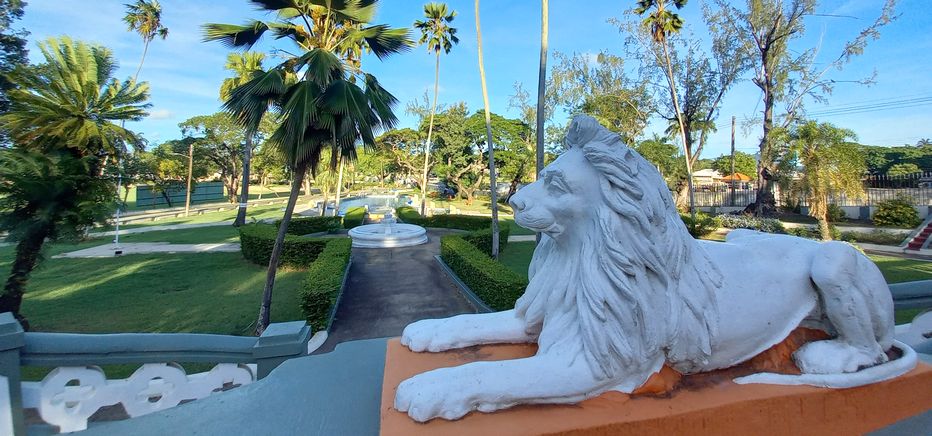 Lion statue stoically overlooking Queen's Park.