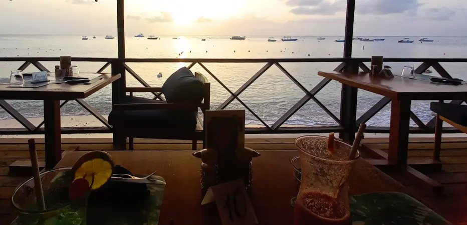 Looking out from a Barbados beachfront restaurant onto the sea and sunset.