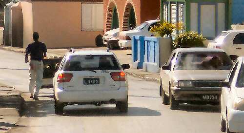 Coconut vendor pushing his cart through traffic