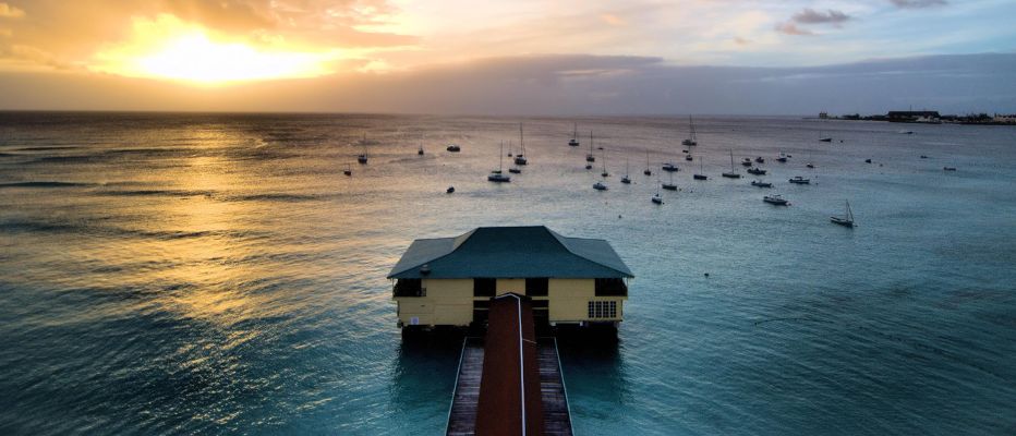 Sunset view of Carlisle Bay with many catamarans and boats in the bay