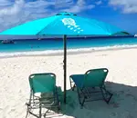 Colorful beach umbrella and loungers on the beach at Carlisle Bay