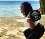 Certified coach leading a BodyPump workout session on the beach in Barbados