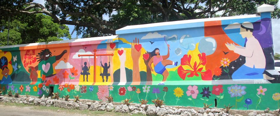 Colorful mural depicting floral and family scenes