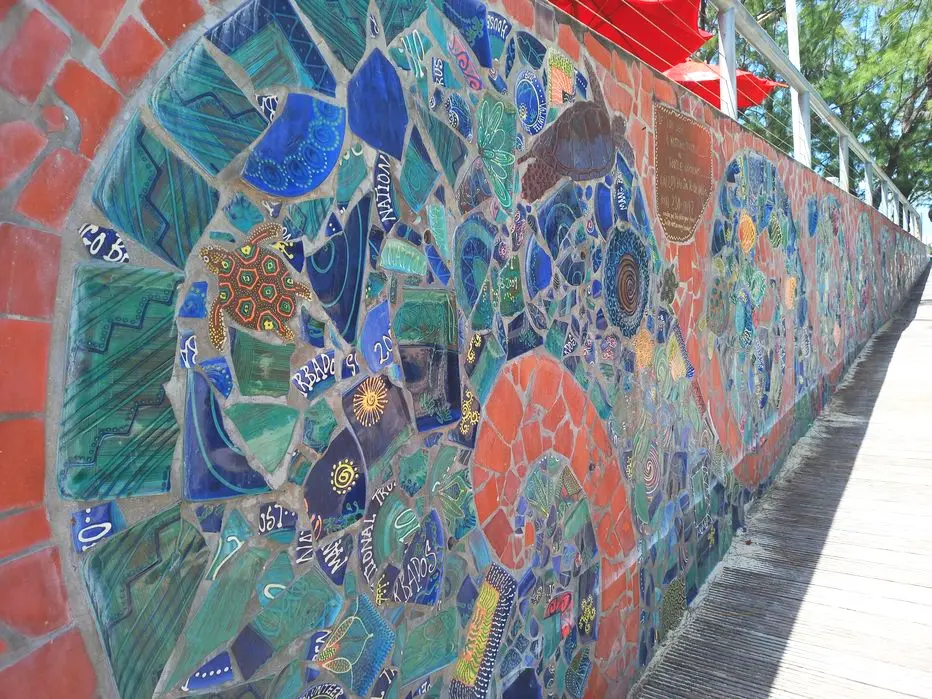 Vibrant mural made from broken ceramics on the wall along the boardwalk at Hastings Rocks
