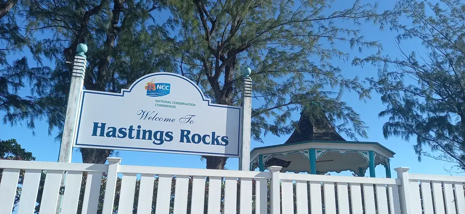 Welcome To hastings Rocks sign, with bandstand in the background