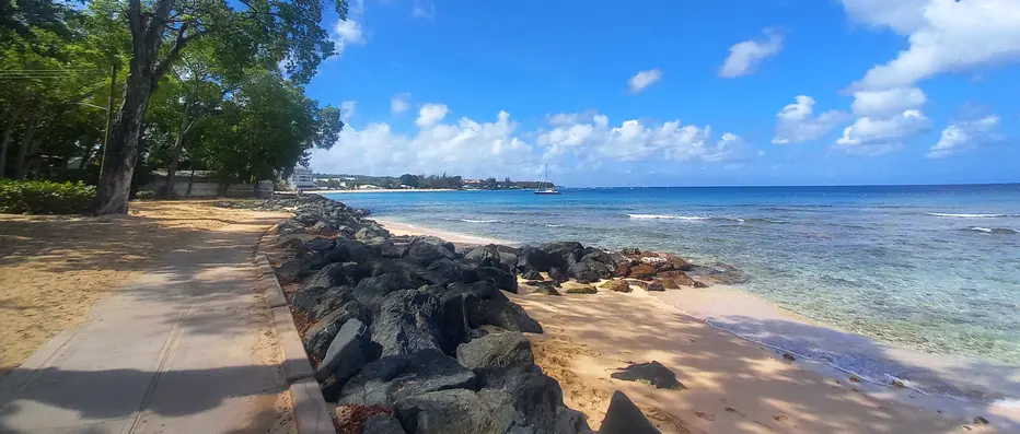 Shaded boardwalk stroll alongside turquoise seas
