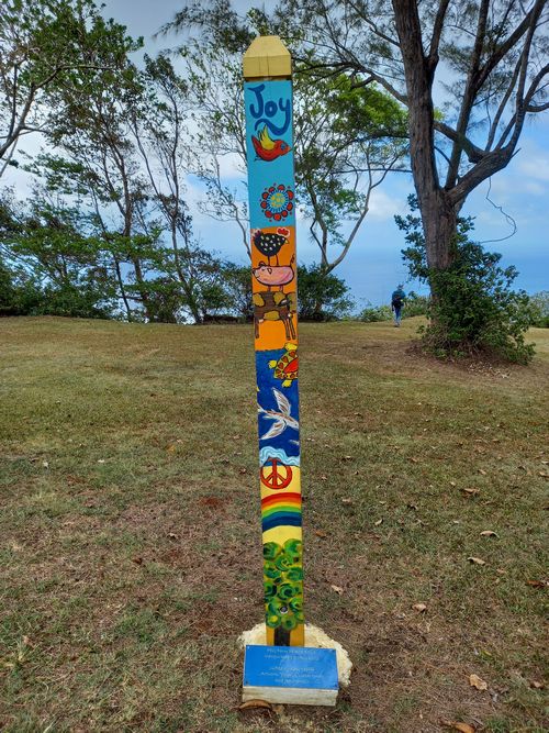 Colorful and whimsically designed PEACE POLE at PEG Farm