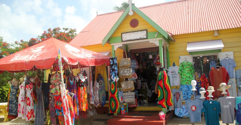 One of the shops in the Chattel House Shopping Village showcasing a wide selection of colorful clothing
