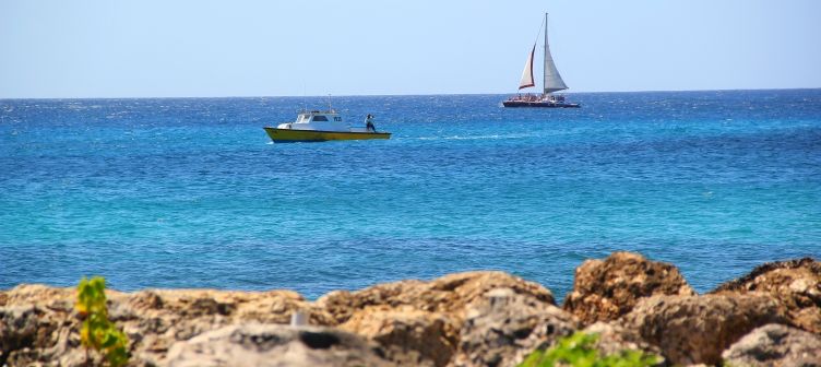 Fishing boat and catamaran sailing past Trevor's Way