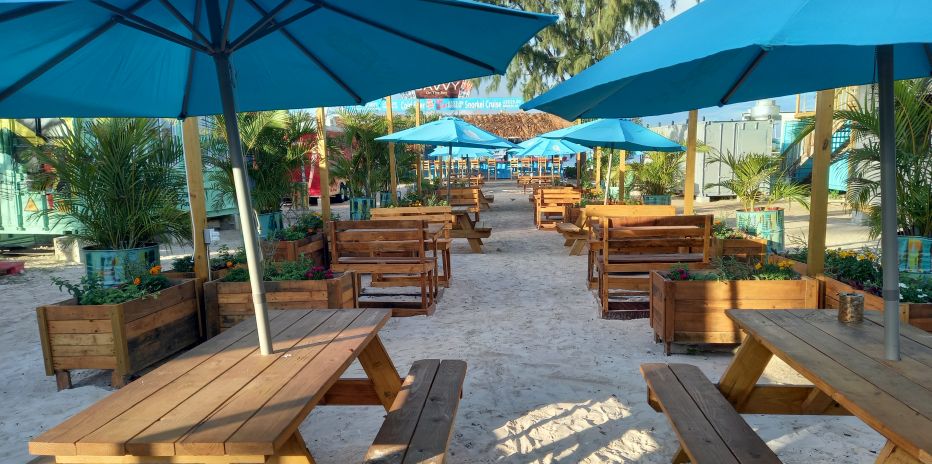 Casual picnic bench seating beachside at Savvy On The Bay