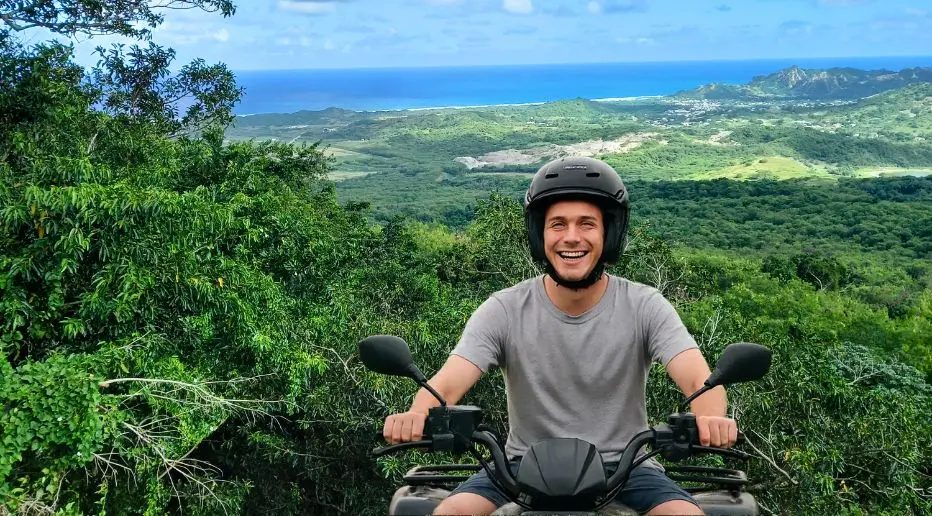 Young man smiling as he rides an ATV